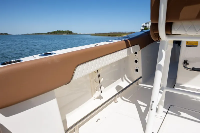 Slide: The Image of 2022 Pioneer 202 Islander boat interior with brown trim, overlooking serene water. - 13