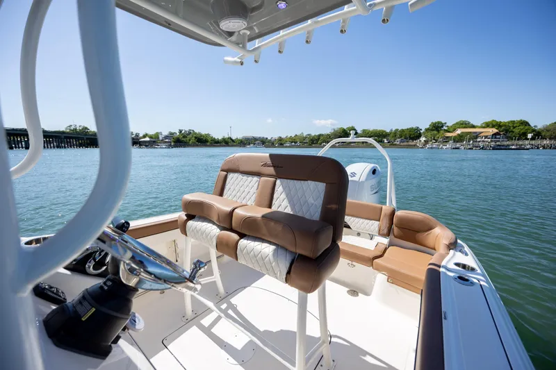 Slide: The Image of 2022 Pioneer 202 Islander boat interior with luxurious seating on a sunny day. - 15