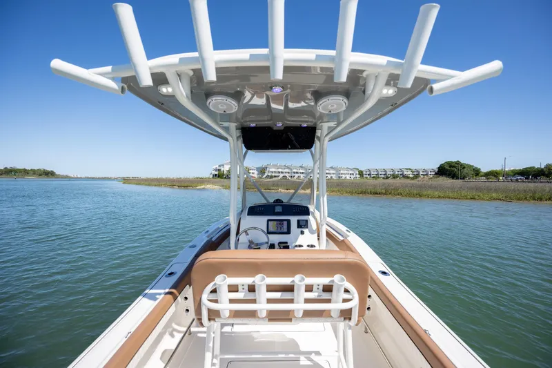 Slide: The Image of 2022 Pioneer 202 Islander boat on calm water with clear blue sky. - 16