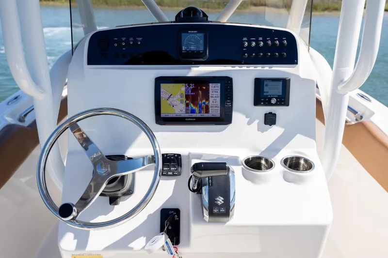 Slide: The Image of 2022 Pioneer 202 Islander boat dashboard with steering wheel, navigation system, and controls. - 20