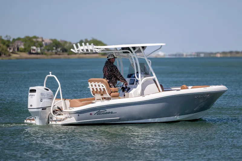 Slide: The Image of 2022 Pioneer 202 Islander boat cruising on a calm lake with a Suzuki engine. - 3