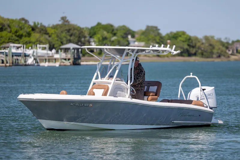 Slide: The Image of 2022 Pioneer 202 Islander boat on water, featuring sleek design and Suzuki outboard motor. - 6