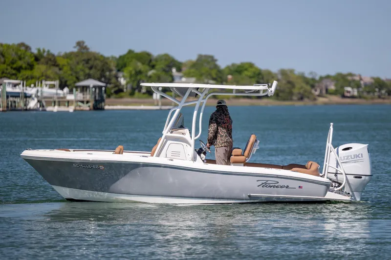 Slide: The Image of 2022 Pioneer 202 Islander boat on calm water with Suzuki outboard motor. - 7