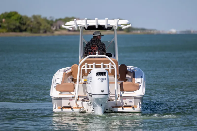 Slide: The Image of 2022 Pioneer 202 Islander boat cruising on calm water with Suzuki outboard motor. - 9