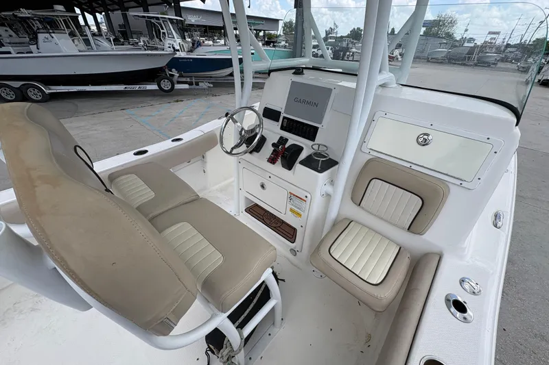 Slide: The Image of 2015 Sea Fox 249 Avenger boat interior with Garmin navigation system and beige seating. - 12
