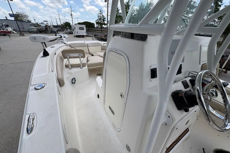 Slide: The Image of 2015 Sea Fox 249 Avenger boat interior with steering wheel and seating area. - 16