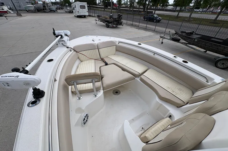 Slide: The Image of 2015 Sea Fox 249 Avenger boat interior with cushioned seating and trolling motor. - 17