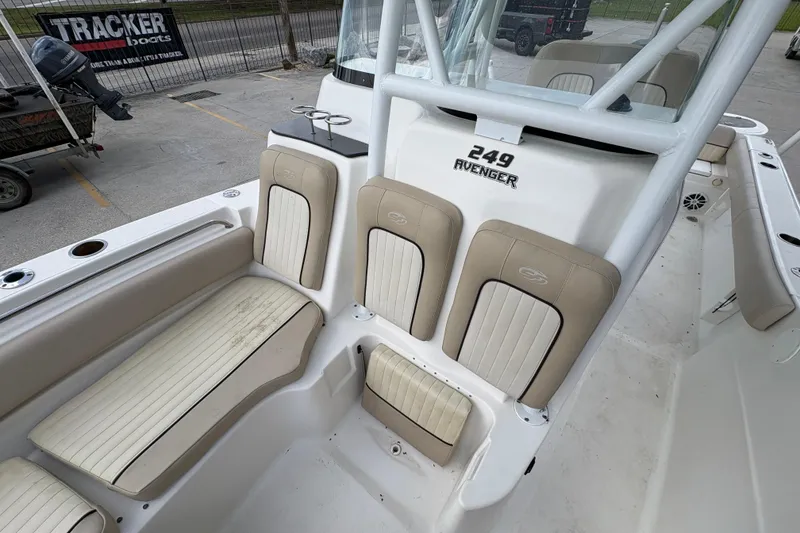 Slide: The Image of 2015 Sea Fox 249 Avenger boat interior with beige seating and console. - 18