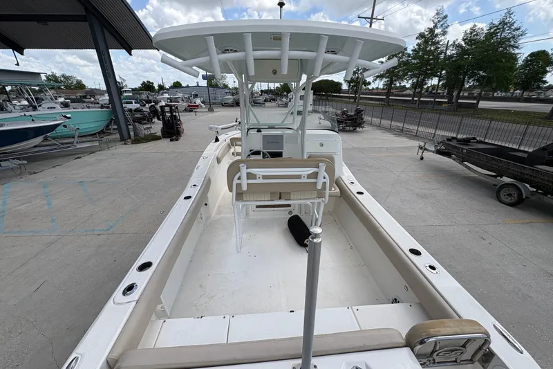 Slide: The Image of 2015 Sea Fox 249 Avenger boat docked, showcasing spacious deck and seating area. - 21