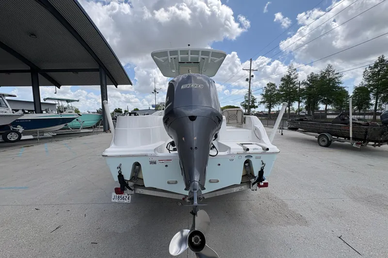 Slide: The Image of 2015 Sea Fox 249 Avenger boat with outboard motor, parked outdoors under cloudy sky. - 4