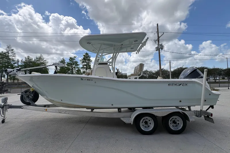 Slide: The Image of 2015 Sea Fox 249 Avenger boat on trailer under cloudy sky. - 6
