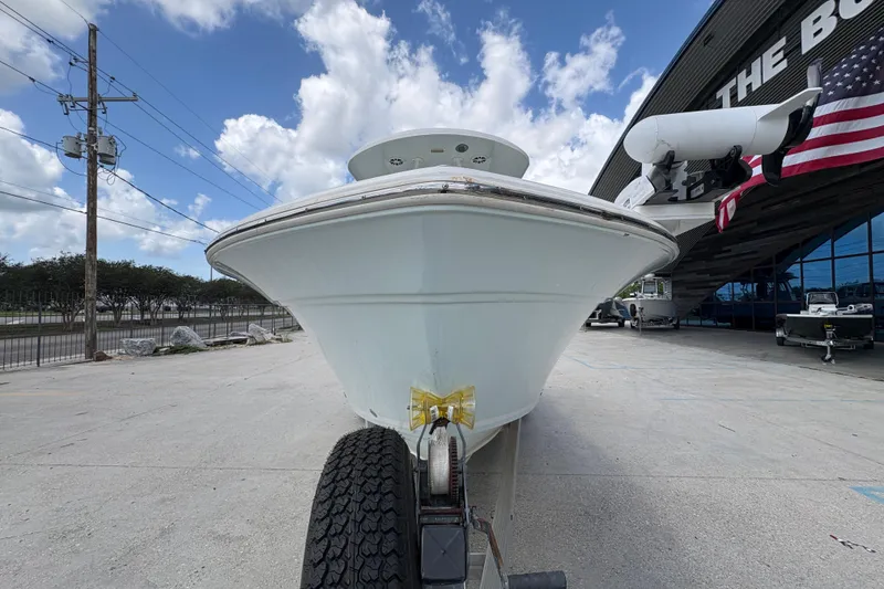 Slide: The Image of 2015 Sea Fox 249 Avenger boat on trailer, parked outside dealership under blue sky. - 8