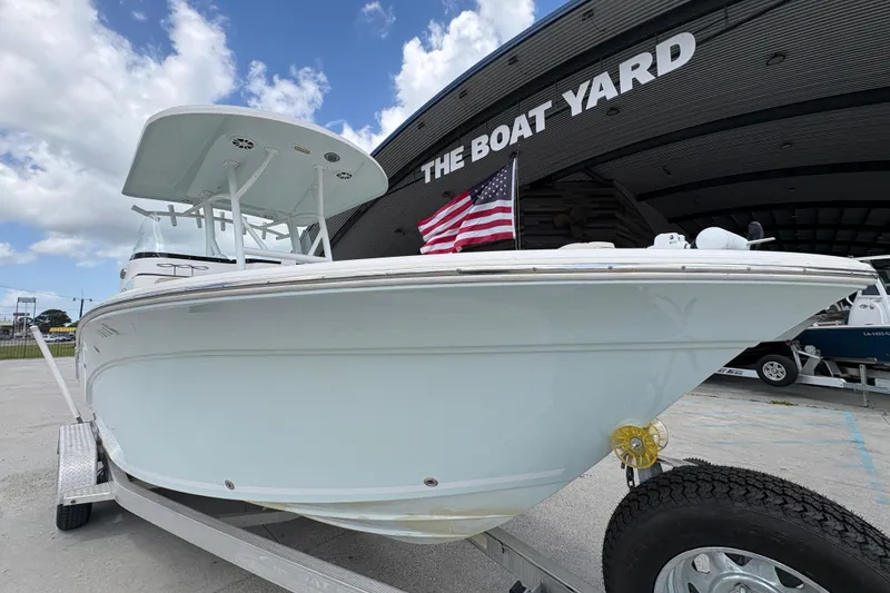 Slide: The Image of 2015 Sea Fox 249 Avenger boat on trailer at The Boat Yard, under a blue sky. - 9