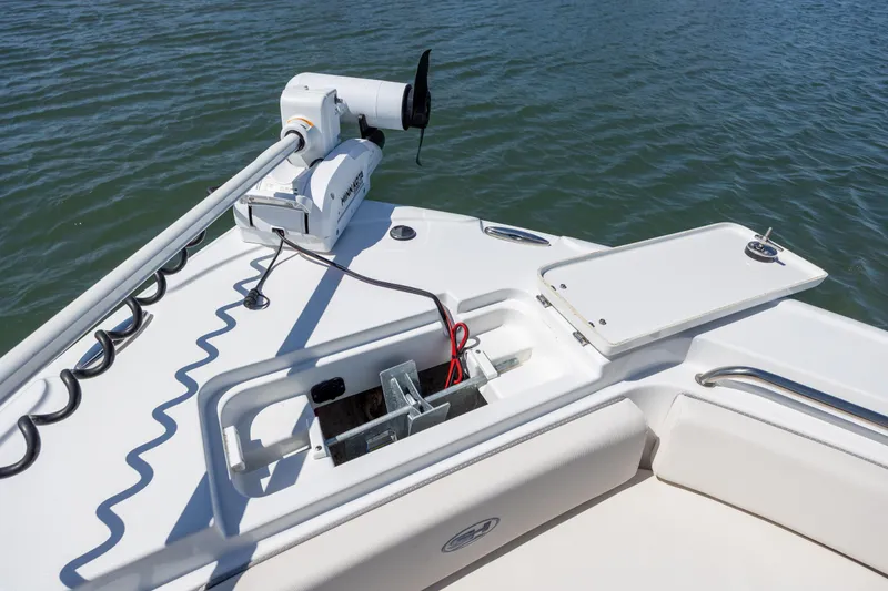 Slide: The Image of 2024 Sea Hunt Ultra 234 boat bow with trolling motor and anchor storage. - 16