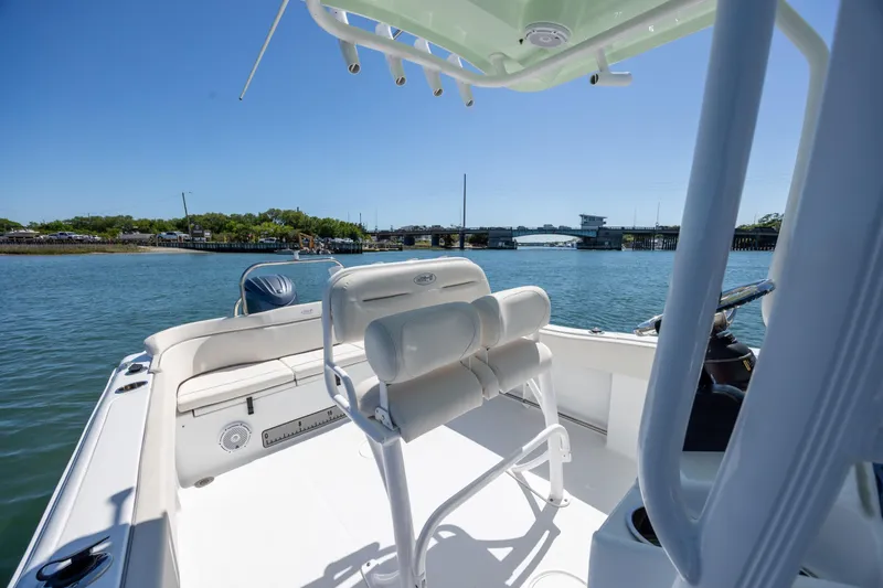 Slide: The Image of 2024 Sea Hunt Ultra 234 boat on water, featuring sleek seating and open deck design. - 22