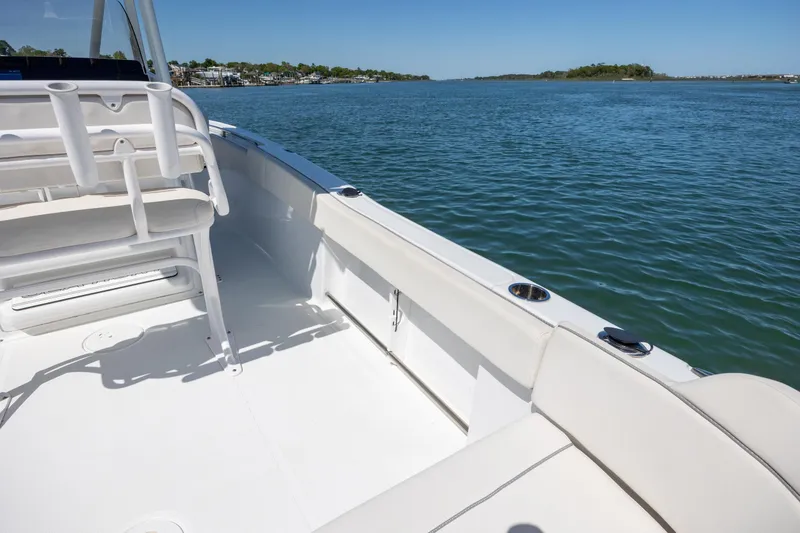 Slide: The Image of 2024 Sea Hunt Ultra 234 boat interior with seating, overlooking calm blue waters. - 25