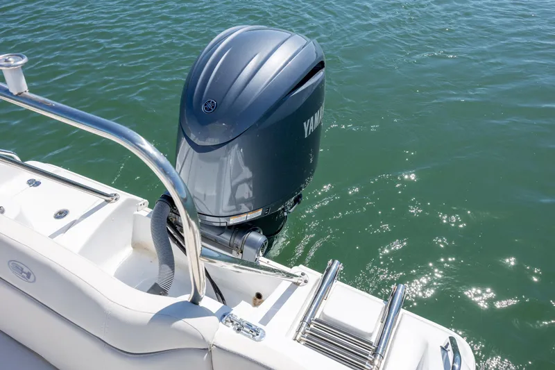 Slide: The Image of 2024 Sea Hunt Ultra 234 boat with Yamaha outboard motor on calm water. - 36