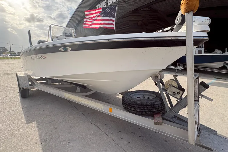 Slide: The Image of 2012 BlackJack 224 boat on trailer with American flag in background. - 10