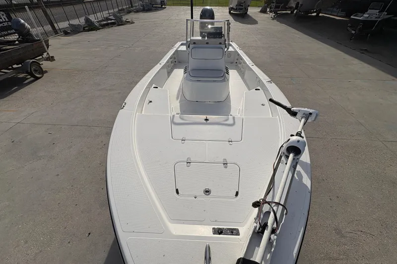 Slide: The Image of 2012 BlackJack 224 boat on concrete surface, featuring a sleek white deck design. - 11