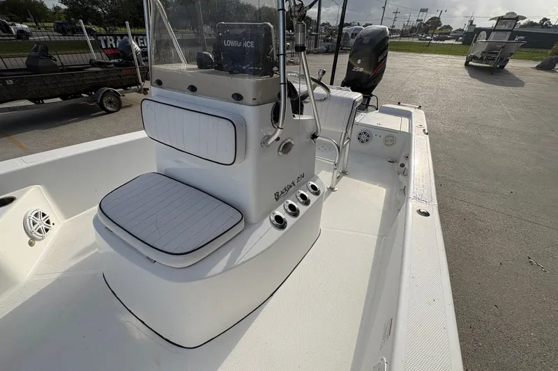 Slide: The Image of 2012 BlackJack 224 boat interior with seating and control panel. - 15
