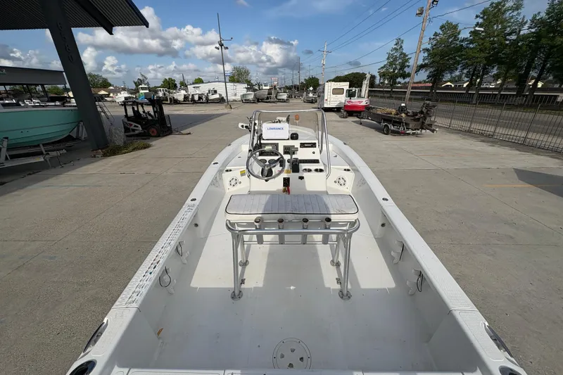 Slide: The Image of Open deck of a 2012 BlackJack 224 boat, parked outdoors under a clear sky. - 17