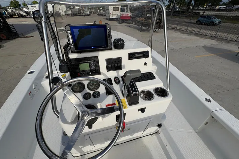 Slide: The Image of 2012 BlackJack 224 boat console with steering wheel, gauges, and navigation equipment. - 19