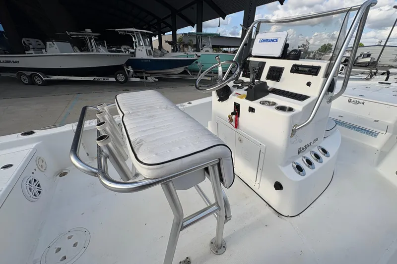 Slide: The Image of Center console of a 2012 BlackJack 224 boat with steering wheel and controls. - 20