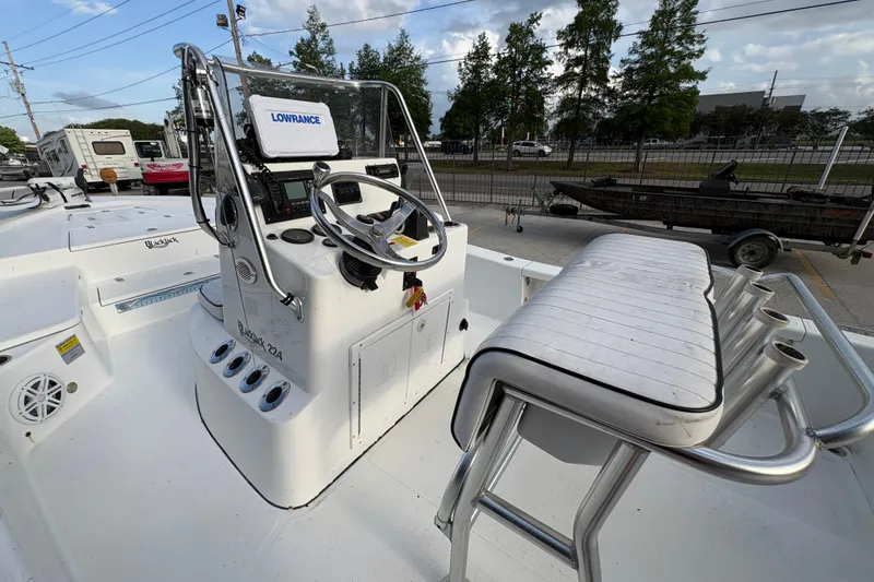 Slide: The Image of 2012 BlackJack 224 boat cockpit with steering wheel and Lowrance navigation system. - 21