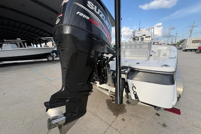 Slide: The Image of 2012 BlackJack 224 boat with Suzuki Four Stroke outboard motor at a marina. - 22