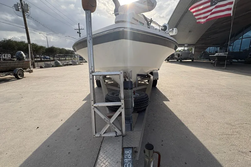 Slide: The Image of 2012 BlackJack 224 boat on trailer, parked outdoors with American flag in background. - 9