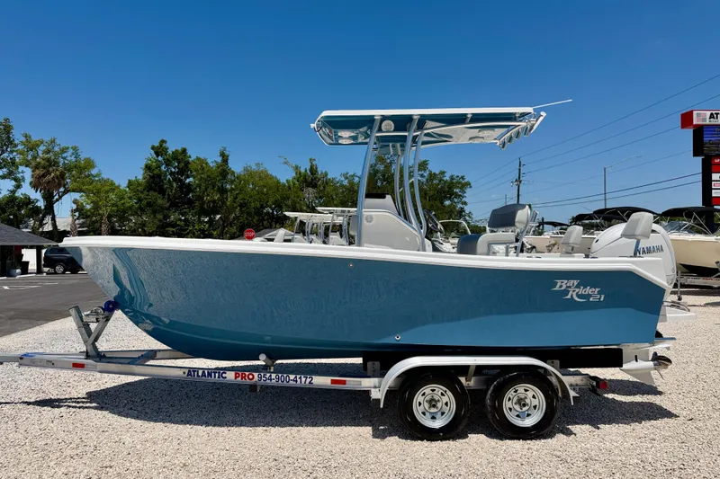 The Image of 2026 Bay Rider 21 Offshore boat on trailer, blue hull, parked outdoors under clear sky. - 0