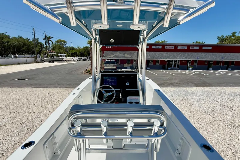 Slide: The Image of Bay Rider 21 Offshore 2026 boat interior with steering console and seating, parked outdoors. - 20