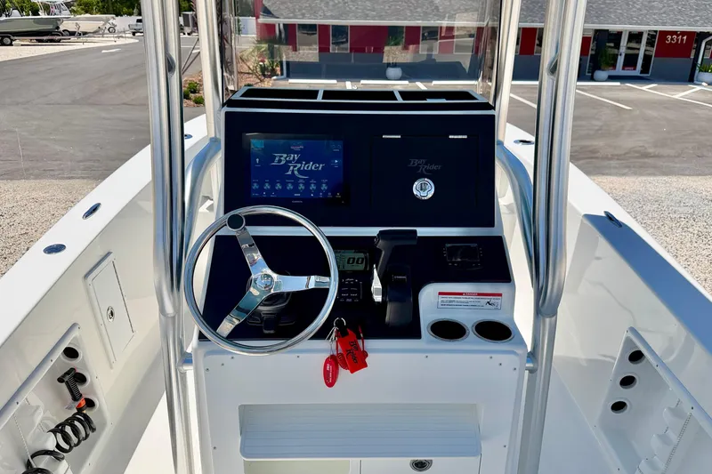 Slide: The Image of 2026 Bay Rider 21 Offshore boat console with steering wheel and control panel. - 21