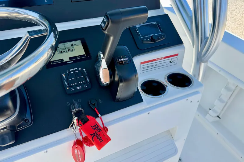 Slide: The Image of 2026 Bay Rider 21 Offshore boat console with Yamaha controls and Bay Rider keychain. - 23