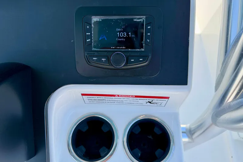 Slide: The Image of Control panel of 2026 Bay Rider 21 Offshore boat with radio and cup holders. - 24