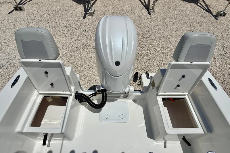 Slide: The Image of 2026 Bay Rider 21 Offshore boat with open storage compartments and outboard motor. - 27