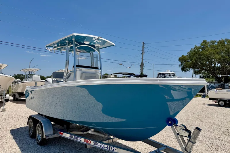 Slide: The Image of 2026 Bay Rider 21 Offshore boat on trailer, displayed outdoors under clear blue sky. - 3