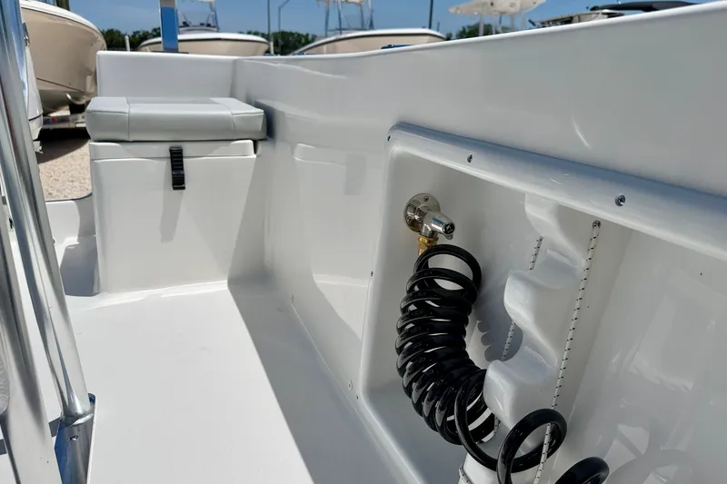Slide: The Image of 2026 Bay Rider 21 Offshore boat interior with seating and coiled hose detail. - 32