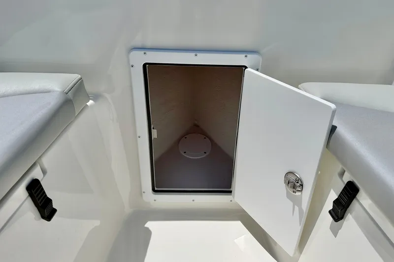 Slide: The Image of 2026 Bay Rider 21 Offshore boat storage compartment with open door. - 37