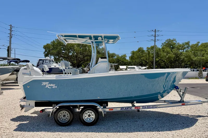 Slide: The Image of 2026 Bay Rider 21 Offshore boat on trailer, featuring sleek blue design and Yamaha engine. - 4