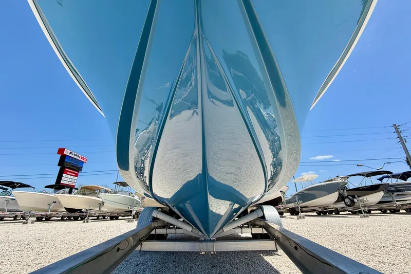 Slide: The Image of 2026 Bay Rider 21 Offshore boat on trailer, viewed from below, in a sunny dealership lot. - 40