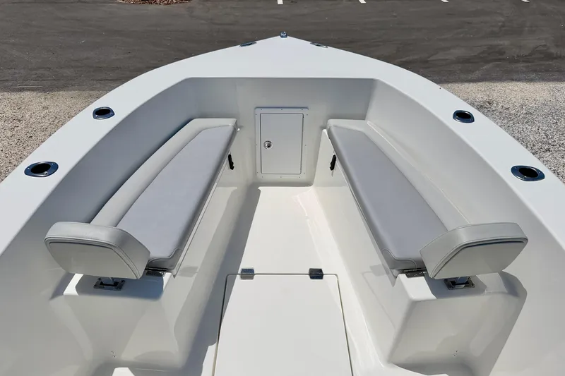 Slide: The Image of 2026 Bay Rider 21 Offshore boat interior with cushioned seating and storage compartment. - 9