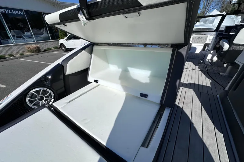 Slide: The Image of 2021 Yamaha Boats 252S storage compartment open, showcasing spacious interior design. - 12