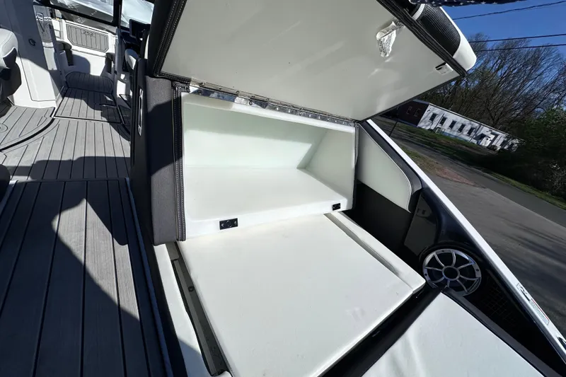 Slide: The Image of 2021 Yamaha Boats 252S storage compartment open, showcasing spacious interior and sleek design. - 13