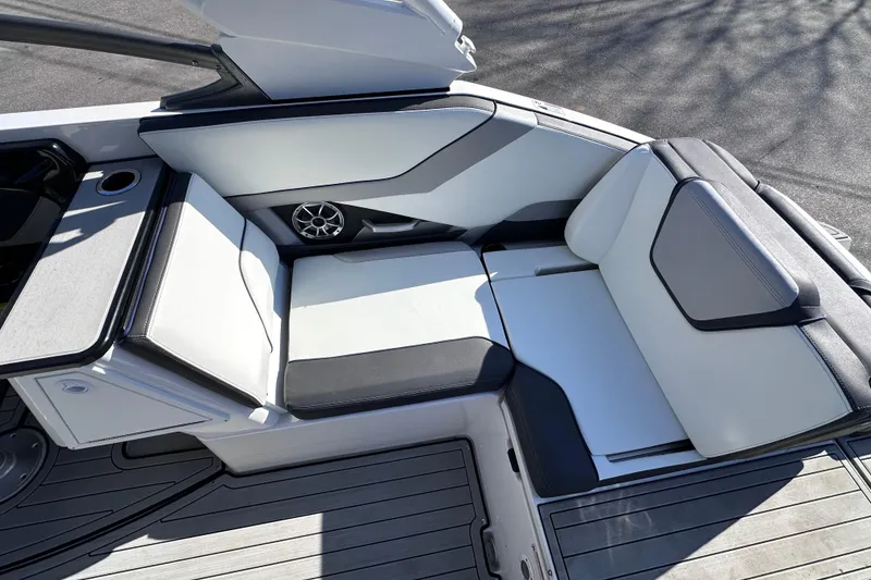 Slide: The Image of 2021 Yamaha Boats 252S interior seating with sleek design and integrated speaker system. - 23