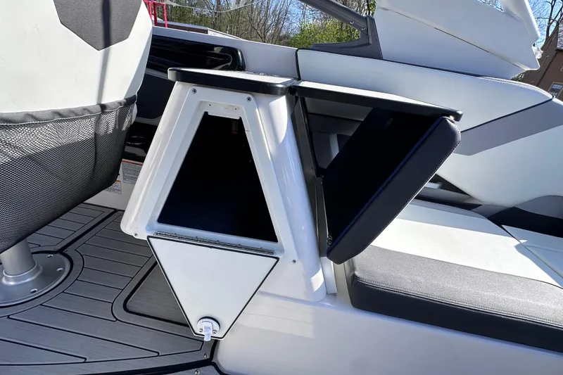 Slide: The Image of 2021 Yamaha Boats 252S interior storage compartment with open hatch, showcasing sleek design. - 26