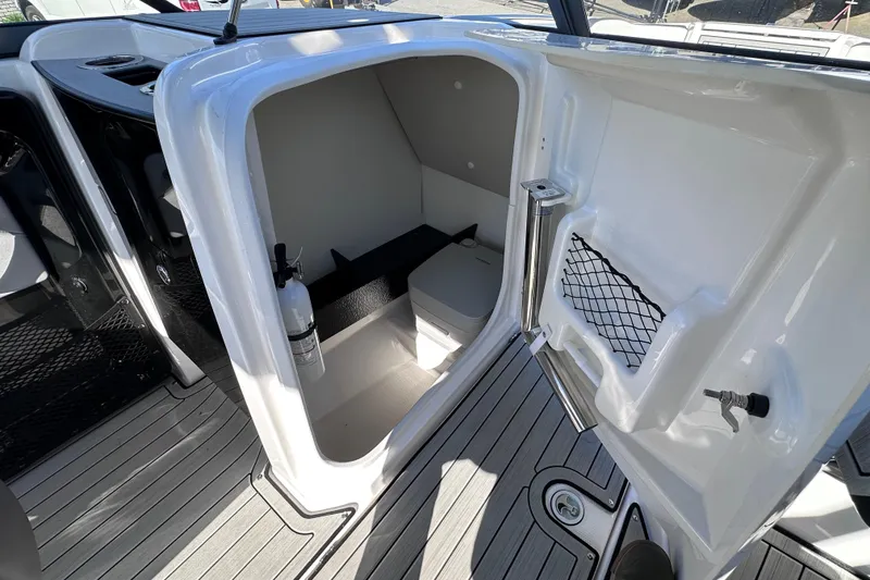 Slide: The Image of 2021 Yamaha Boats 252S interior showing compact cabin with seating and storage. - 32