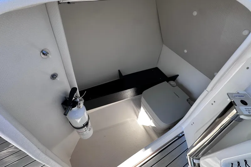 Slide: The Image of 2021 Yamaha Boats 252S interior with portable toilet and fire extinguisher. - 33