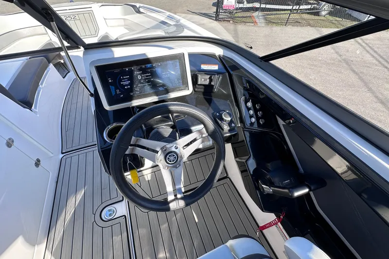 Slide: The Image of 2021 Yamaha Boats 252S helm with touchscreen display and sleek steering wheel design. - 35