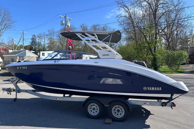 Slide: The Image of 2021 Yamaha Boats 252S on trailer, parked outdoors, showcasing sleek design and modern features. - 4